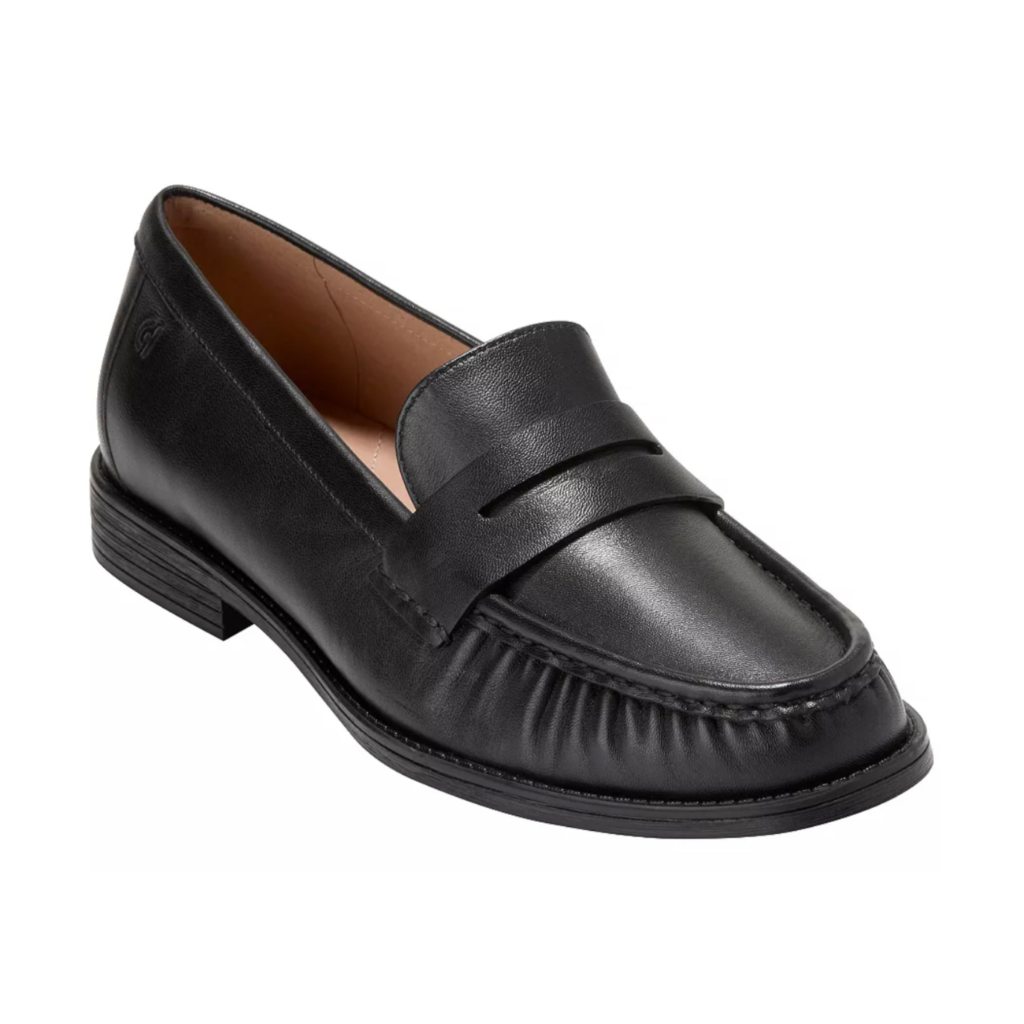 Cole Haan Stassi Soft Slip-On Loafers in black leather with a flexible sole and almond toe, displayed on a clean white background.