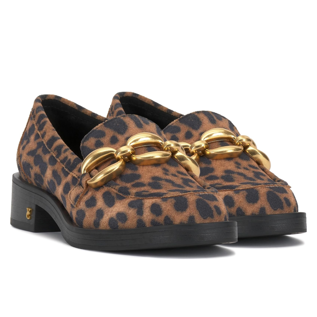 Vince Camuto Sayer women's loafers featuring a bold leopard print calf hair finish and a chunky gold oversized chain detail on a white background.