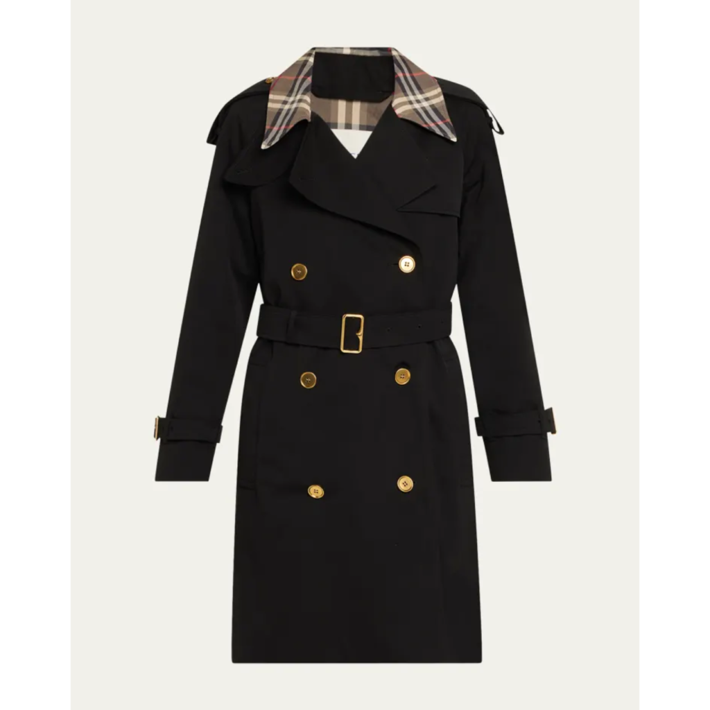 Close-up of a black Burberry Castleford short trench coat featuring double-breasted gold buttons, a belted waist, and a glimpse of the iconic check pattern on the under-collar.