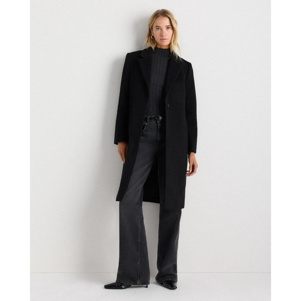The Quince Wool Cashmere Single-Breasted Coat in black, featuring a streamlined slim-fit silhouette, notched lapels, and a clean three-button closure for a 90s minimalist aesthetic.