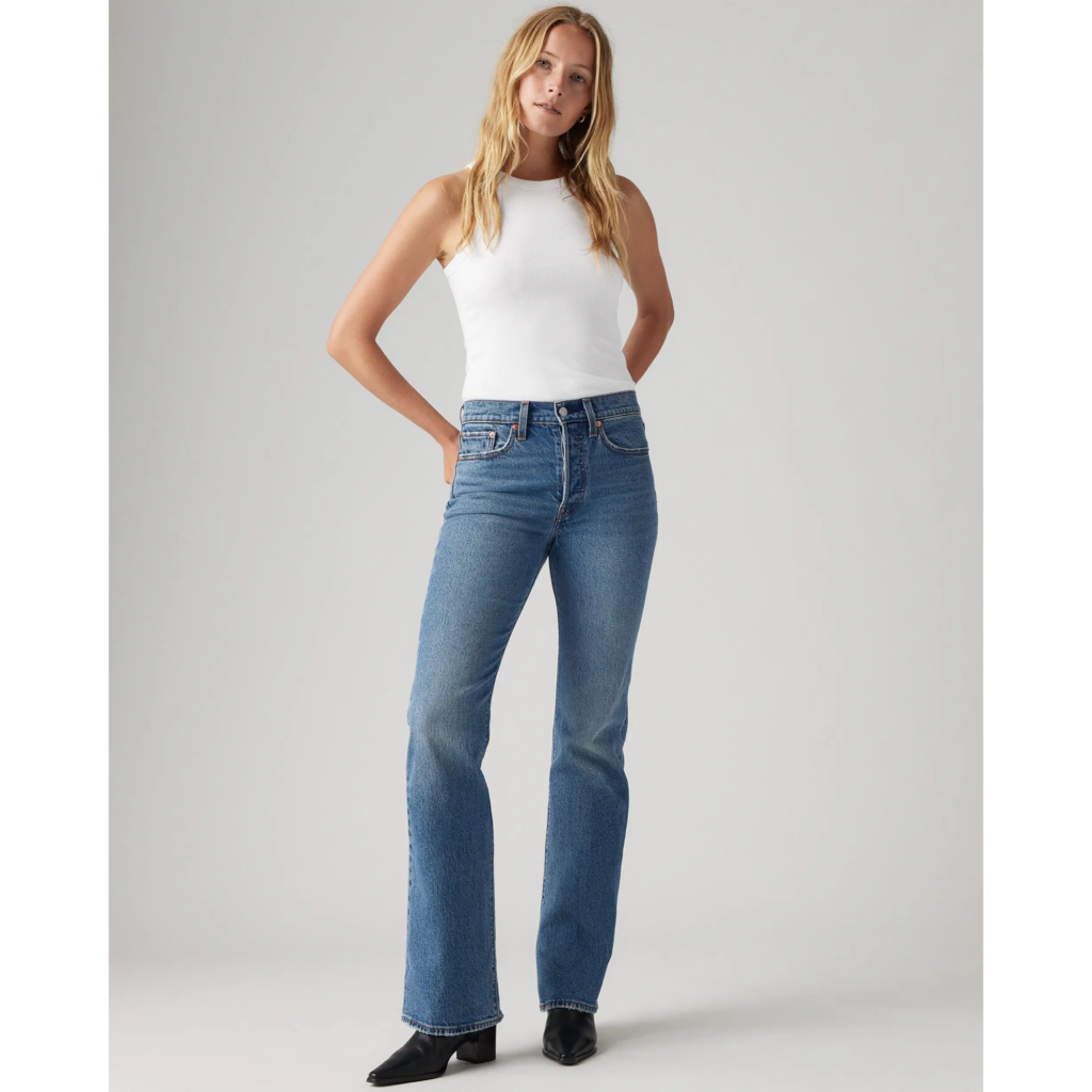 A model wearing Levi’s Wedgie Bootcut Jeans in a classic medium blue wash, featuring a high-rise waist and a slight flare at the ankle for a modern 90s-inspired look.