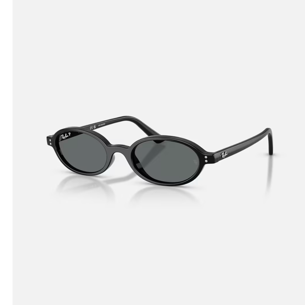 A pair of Ray-Ban Khal Bio-Based Sunglasses in black, featuring a sleek, slim oval frame and dark lenses that define the 90s minimalist accessory aesthetic.