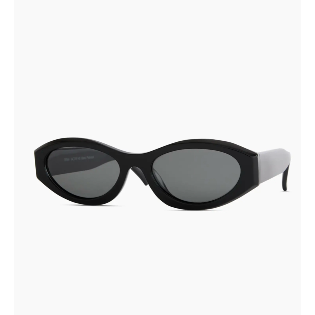 A pair of Quince Milan Acetate Sunglasses in black, featuring a wide-frame oval silhouette and dark lenses that mirror the classic 90s minimalism signature look.